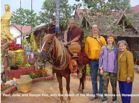 ALT =[“Dr. Jolie Bookspan: WIth husband Paul meeting the Horseback Muay Thai Monks of Thailand”] 
