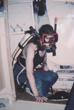 ALT =[“Dr. Jolie Bookspan: Dr. Bookspan getting ready to leave the hatch of the underwater lab for data collection outside”]
